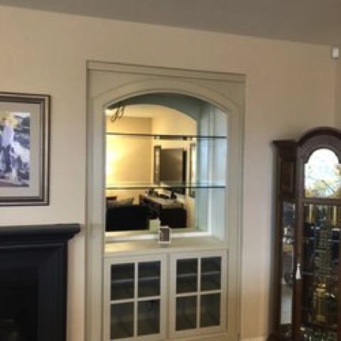 Wine bar with curved molding and mirror